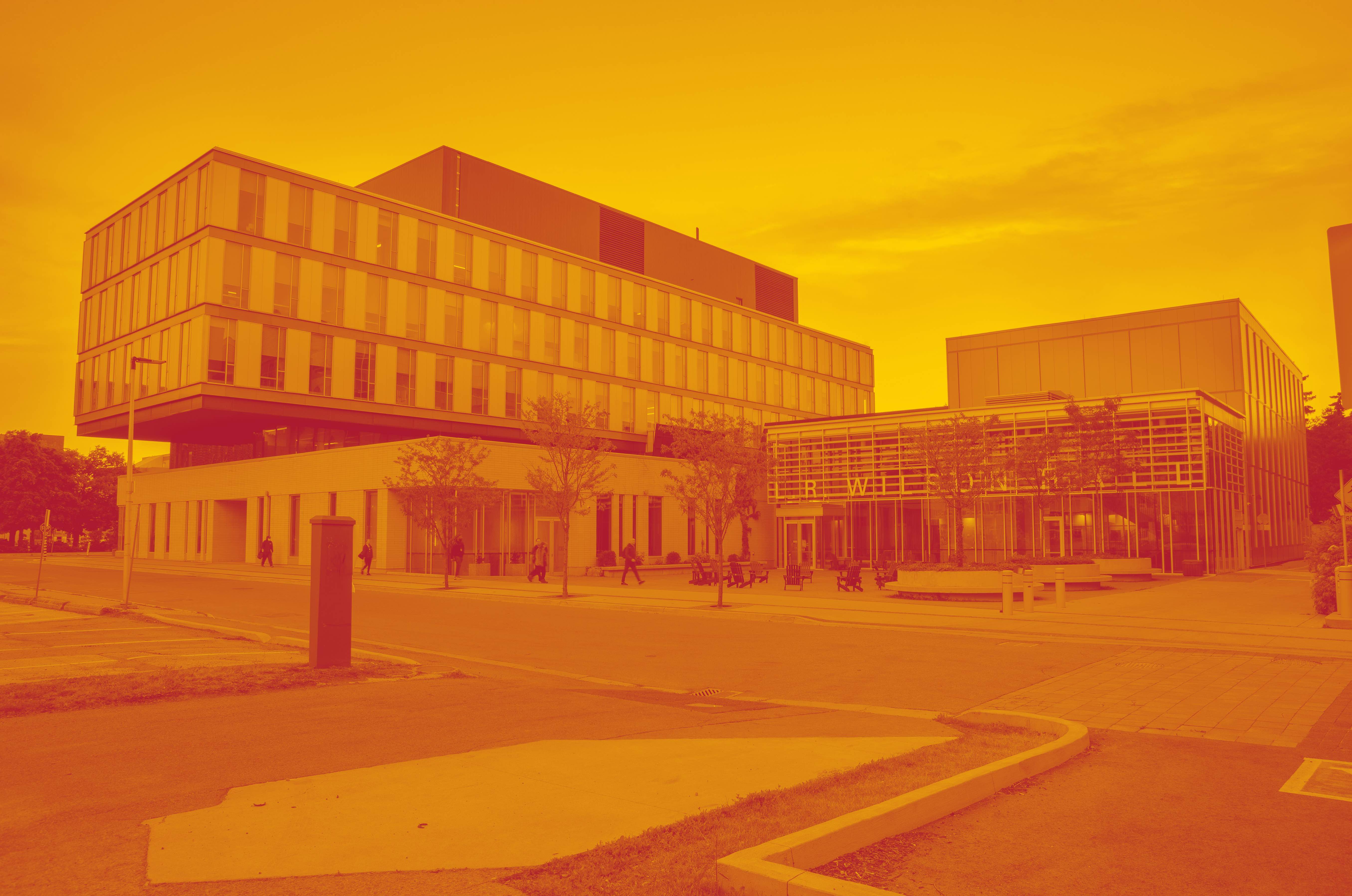 Image features the outside of the LR Wilson building. The Spark Centre is located within LR Wilson. A yellow and red duotone filter has been placed over the image.